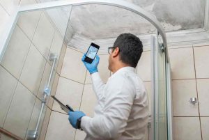 person using phone for Mold INSPECTION